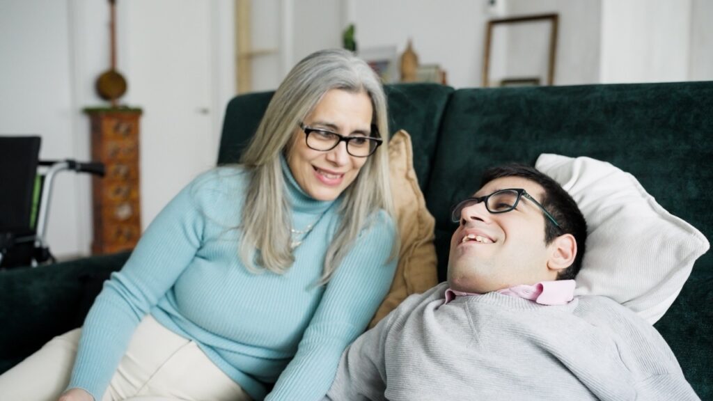 Direct support professional completing service documentation on a tablet using Vertex Case Manager to reduce administrative burden and caregiver burnout at an IDD agency
