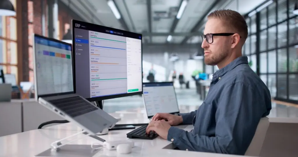IDD agency finance leader reviewing integrated financial management software with real-time revenue data