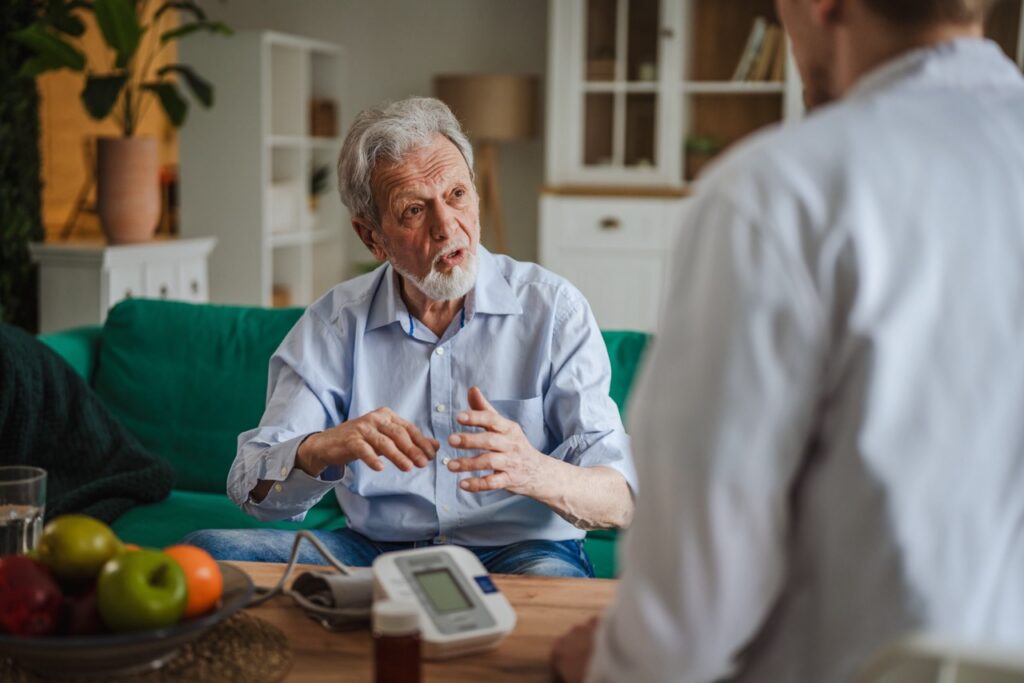 Direct support professional using the Vertex EVV Manager app to clock in for a home visit