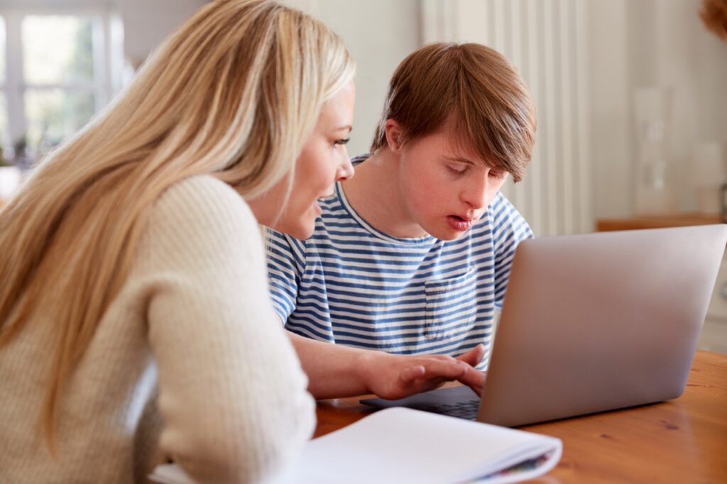 Direct support professional documenting person-centered care on a mobile device with IDD software