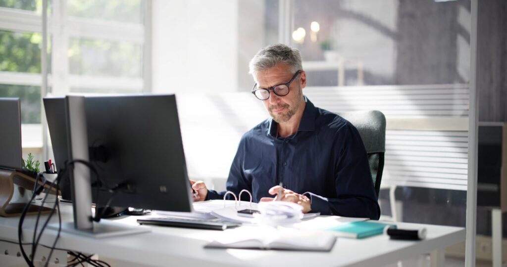 Billing coordinator reviewing linked IDD billing software and case notes