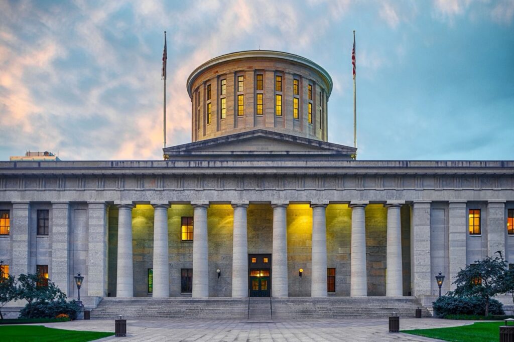 Ohio Statehouse in Columbus at dusk, where policy shaping Ohio DODD billing rules is set